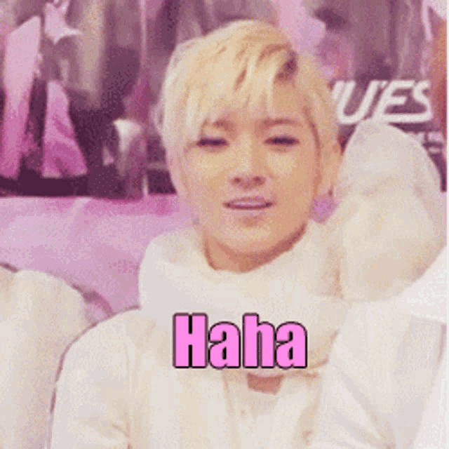 a young man with blonde hair is wearing a white scarf and says " haha " in pink letters