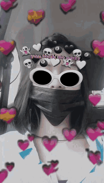 a girl wearing a mask and sunglasses with skulls and hearts and the word you look cool
