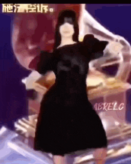 a woman in a black dress is dancing on a stage in front of a grammy award .