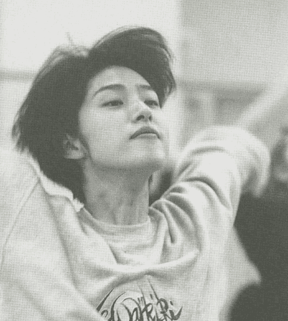 a black and white photo of a person wearing a sweater that says ' dorri ' on it