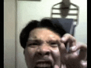 a close up of a man making a funny face with his mouth open