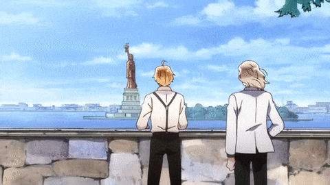 two men are looking at the statue of liberty in new york