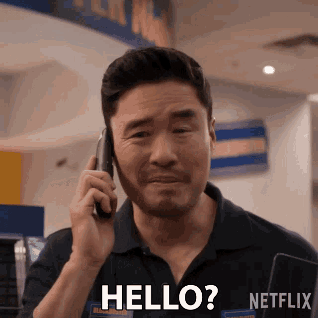 a man talking on a cell phone with the words hello written on the screen