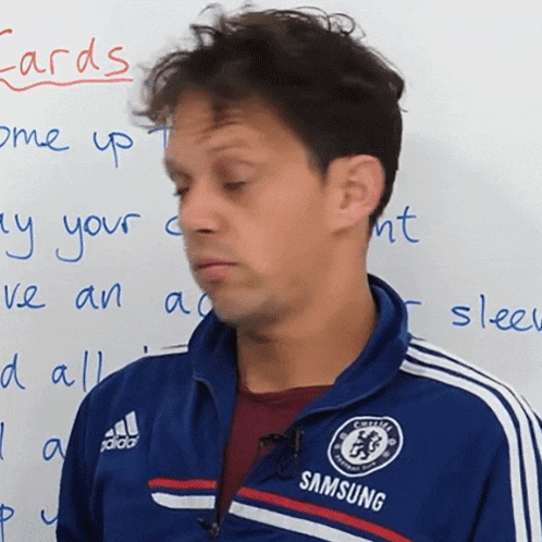 a man in a blue samsung jacket stands in front of a white board