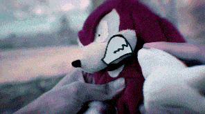 a person is holding a stuffed animal with a drawing of a face on it