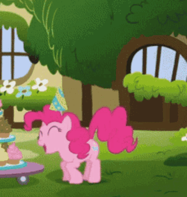 pinkie pie from my little pony is standing in front of a cake stand