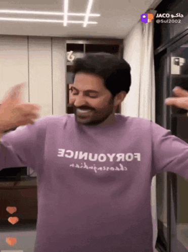 a man is wearing a purple shirt that says ' ioiuoyяo9 ' on it