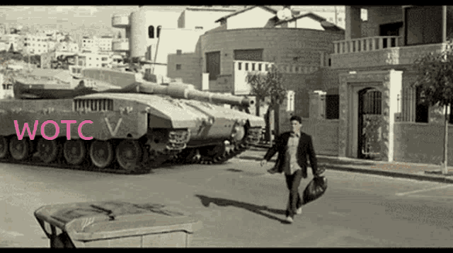 a man is walking down a street in front of a tank that says wotc v.