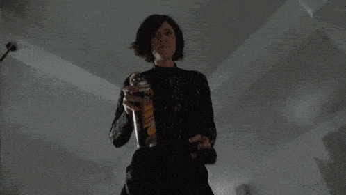 a woman is holding a spray bottle with a label that says ' shaving cream '
