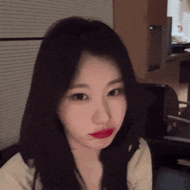 a close up of a woman 's face with red lipstick