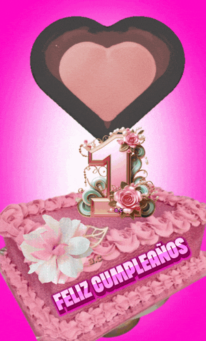 a pink cake with the number 1 on top and the words feliz cumpleanos on the bottom