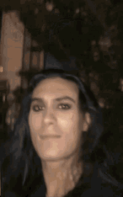 a blurry picture of a woman with a hat on her head
