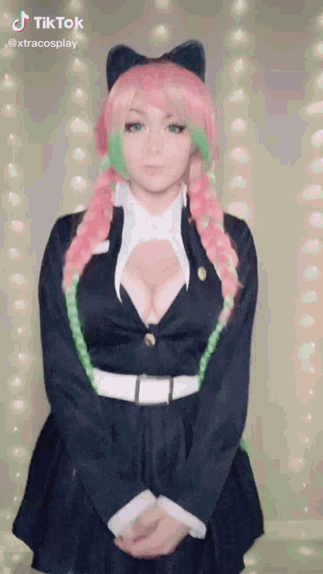 a woman in a cosplay costume with pink hair and cat ears .