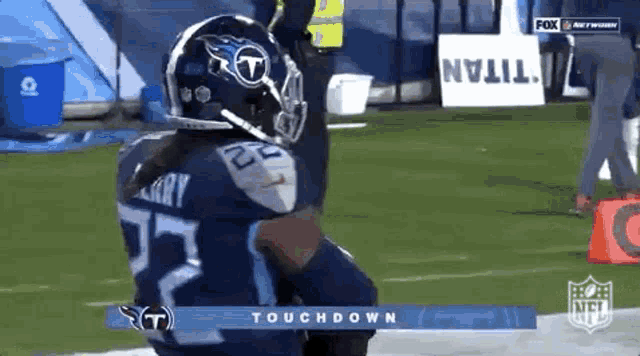 a football player wearing a titans helmet is on the field