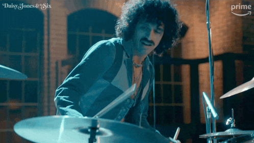 a man is playing drums in a daisy jones and six ad