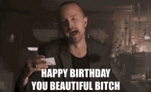 a man in a suit is giving a middle finger and says happy birthday you beautiful bitch .