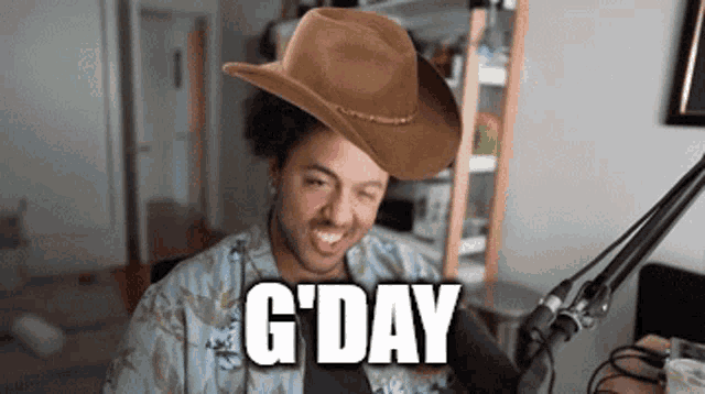 a man wearing a cowboy hat with the word g day on it