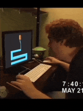 a man playing a game on a computer with the time 7:40 on may 21