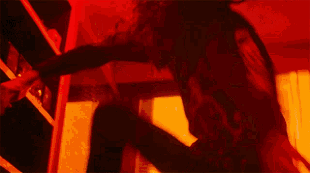 a woman 's head is visible in a blurry photo in a dark room