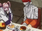 a couple of people are sitting at a table with food . one of the people is wearing a bandage on their face .