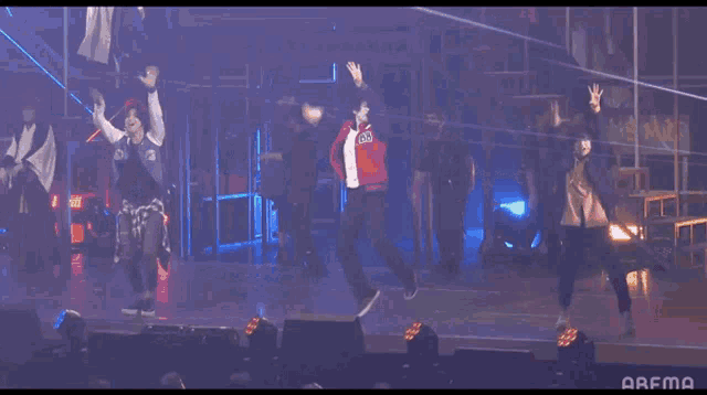 a group of people are dancing on a stage with the word arfma on the bottom right