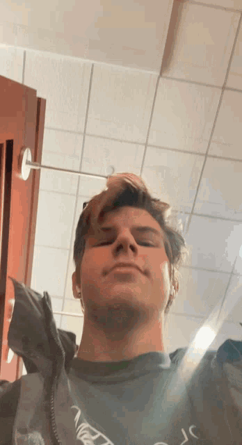 a young man is taking a picture of himself in a mirror