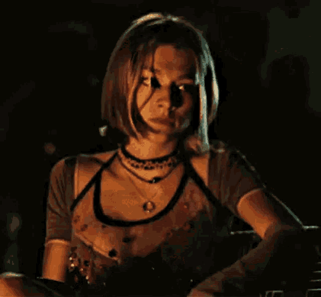a woman is sitting down holding a cell phone in her hands .