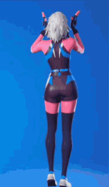 a woman in a pink and blue outfit is standing on a blue surface .