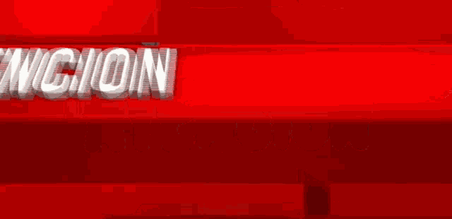 a red sign with the word atencion in white letters