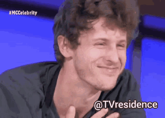 a man with a beard is smiling with the hashtag #mccelebrity in the background