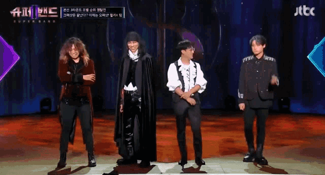 a group of men standing on a stage with jtbc in the corner