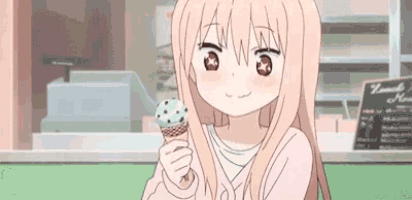 a girl is holding an ice cream cone in her hand in front of a store .