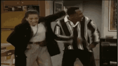 a man and a woman are dancing together in a room .