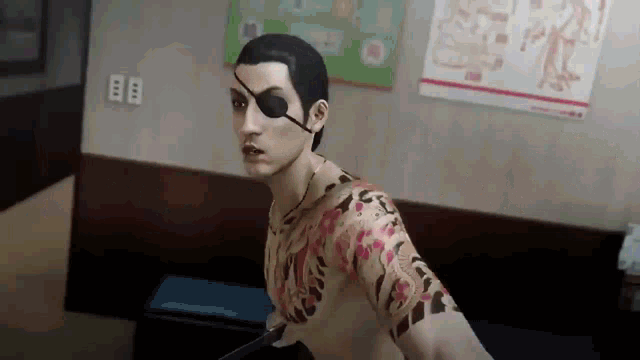 a man with a tattoo on his arm and a eye patch is standing in a room .