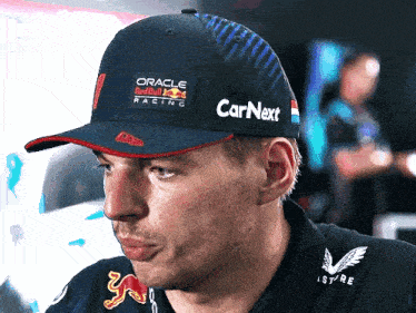 a man wearing an oracle redbull racing hat