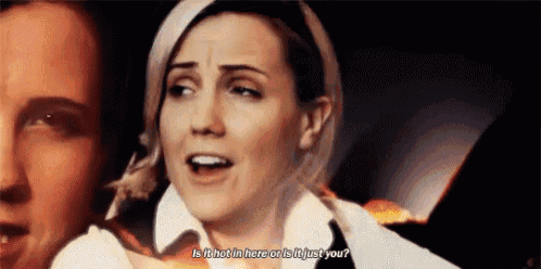 a woman is talking to a man and asking if it is hot in here or is it just you .