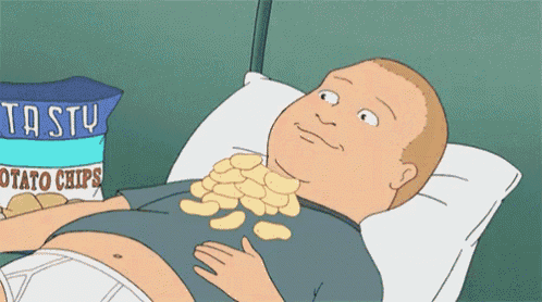 a cartoon man is laying on a bed with a bag of tasty potato chips