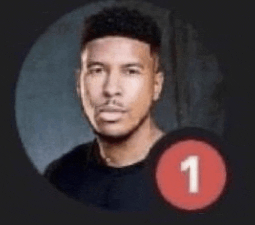 a man in a black shirt is sitting in a circle with a red circle with the number 1 on it .