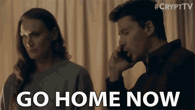 a man is talking on a cell phone while a woman looks on and says go home now .