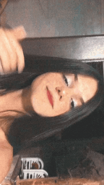 a girl is taking a picture of herself in a mirror with the letter r visible