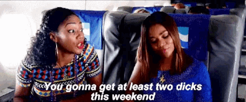 two women are sitting next to each other on a plane and one of them is talking to the other .