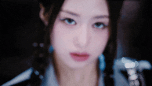 a close up of a woman 's face in a dark room .