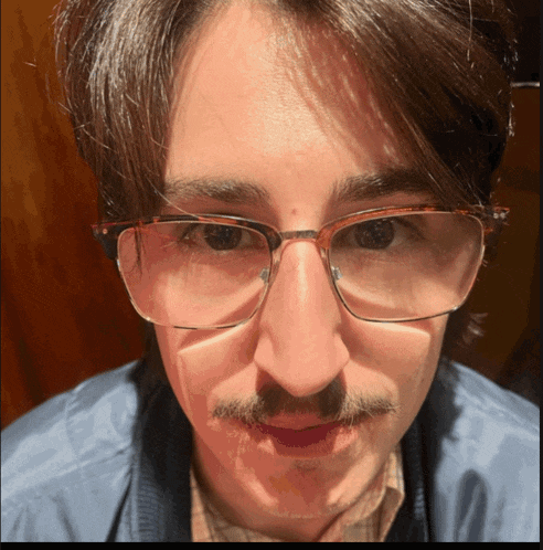 a man with glasses and a mustache is making a funny face