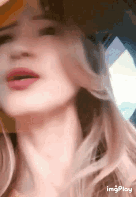 a close up of a woman 's face with the words imgplay below