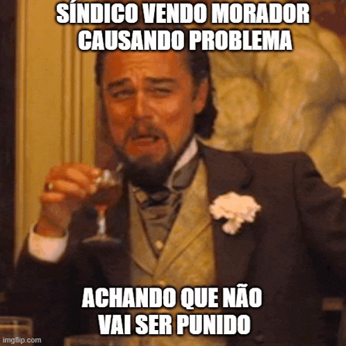 a man in a suit and tie is holding a glass of wine and making a funny face