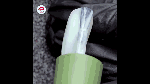 a close up of a nail polish bottle with a brush on it