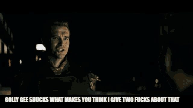 a man is talking to another man in a dark room .