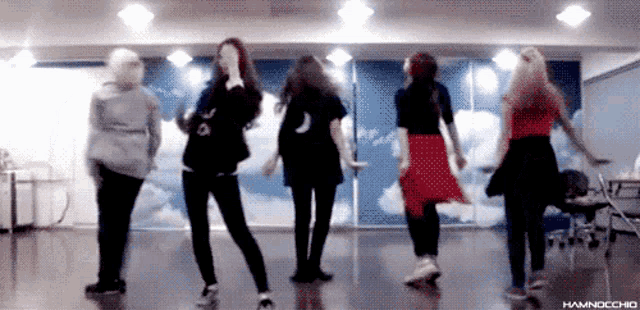 a group of girls are dancing in a room with the word hamnocchio on the bottom right
