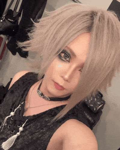 a woman with a choker around her neck takes a picture of herself