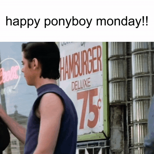 a man standing in front of a sign that says hamburger deluxe 75 cents